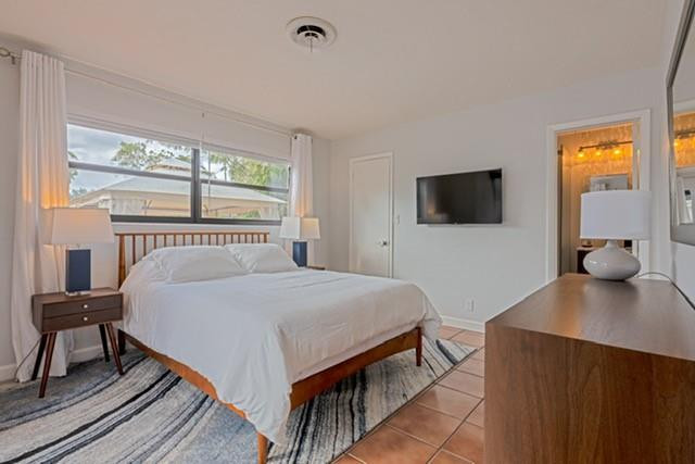 1311 Southwest 56th Avenue Plantation, FL 33317 - Photo 11 of 31 a bedroom with a bed and a flat tv screen on dresser