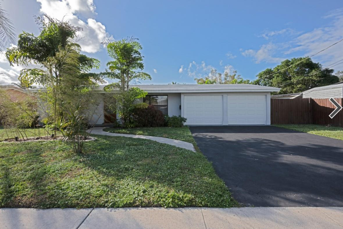 1311 Southwest 56th Avenue Plantation, FL 33317 - Photo 2 of 31 a view of a house with a yard