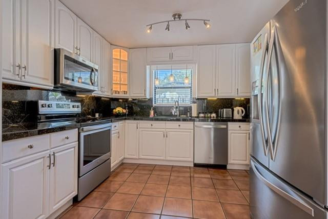 1311 Southwest 56th Avenue Plantation, FL 33317 - Photo 4 of 31 a kitchen with stainless steel appliances granite countertop a refrigerator a sink a stove a microwave and cabinets