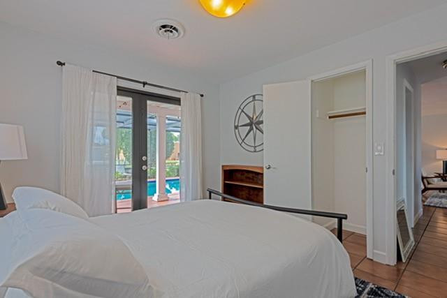 1311 Southwest 56th Avenue Plantation, FL 33317 - Photo 5 of 31 a bedroom with a bed and a chandelier