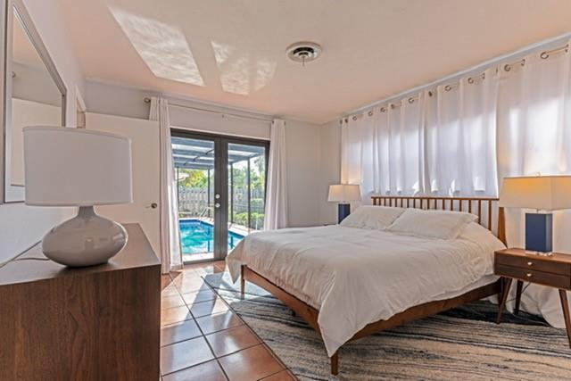 1311 Southwest 56th Avenue Plantation, FL 33317 - Photo 10 of 31 a bedroom with a bed and window