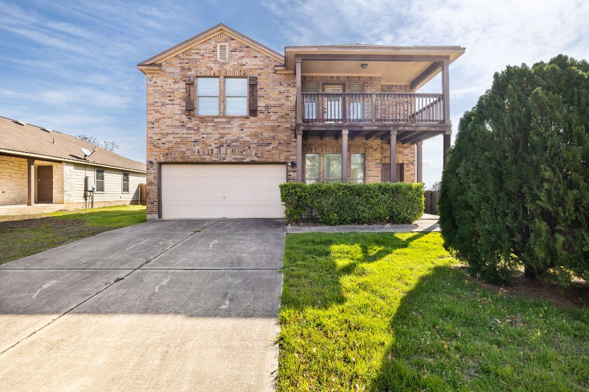 4507 Mellow Hollow Drive Austin, TX 78744 - Photo 1 of 1 a front view of a house with a yard and garage