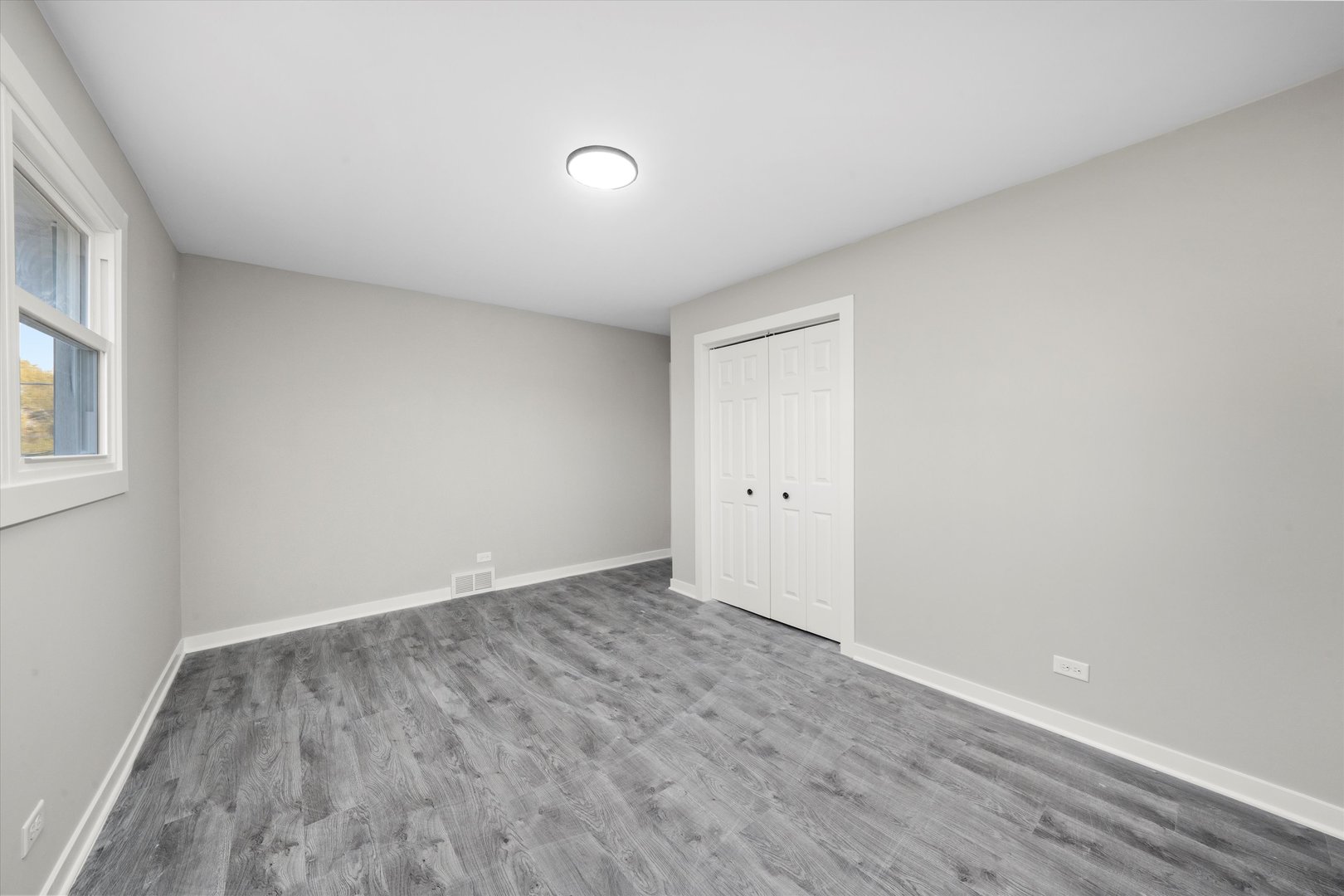 8938 West 85th Place Justice, IL 60458 - Photo 17 of 39 an empty room with wooden floor and windows