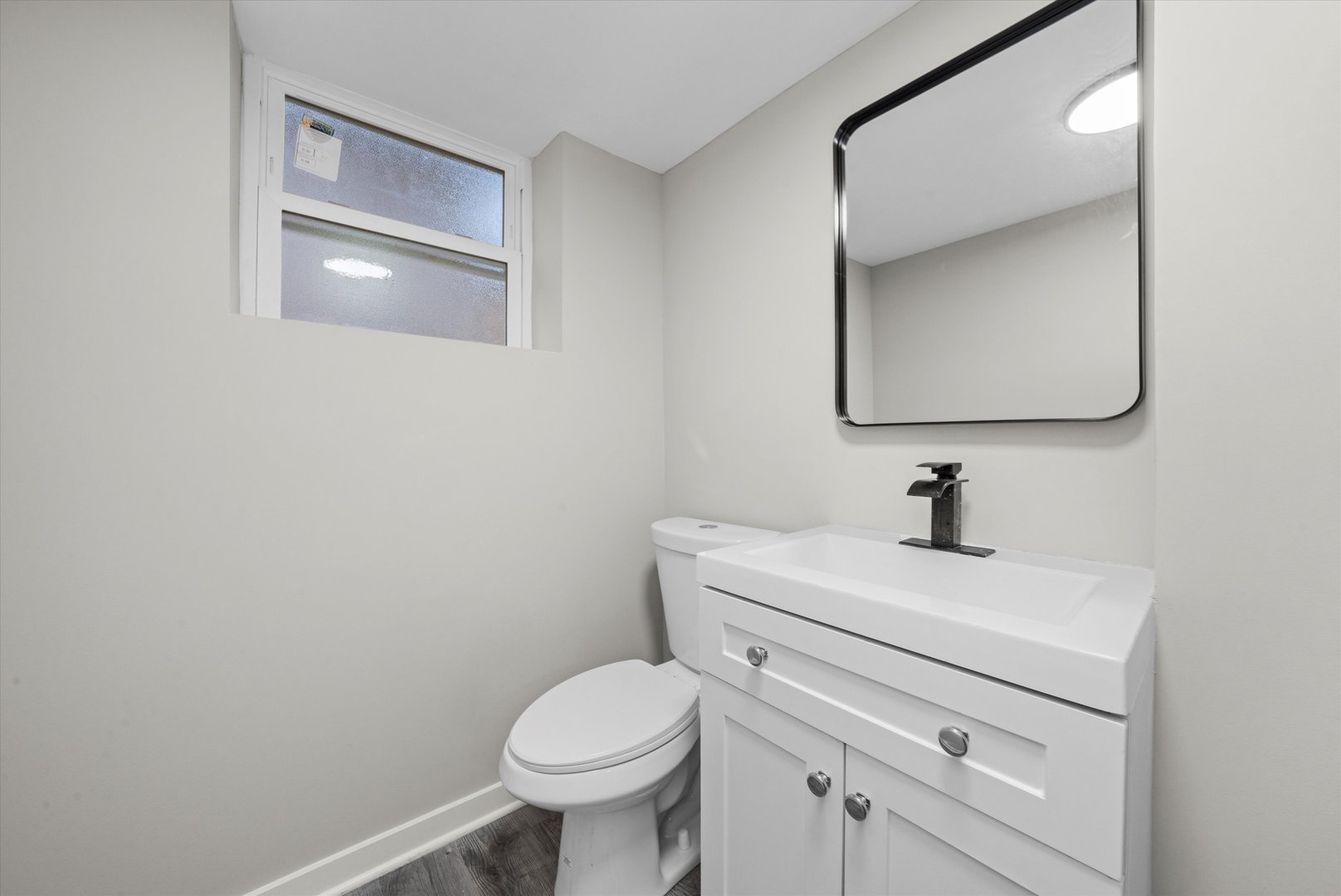 8938 West 85th Place Justice, IL 60458 - Photo 28 of 39 a bathroom with a toilet sink and mirror