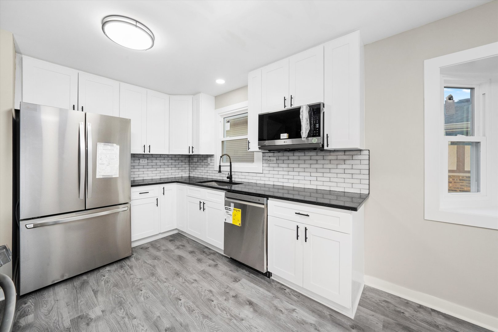 8938 West 85th Place Justice, IL 60458 - Photo 6 of 39 a kitchen with granite countertop a refrigerator stove top oven and sink