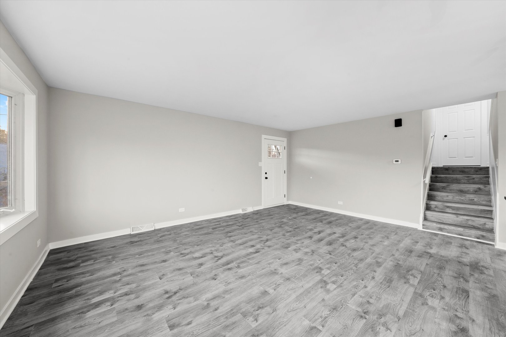 8938 West 85th Place Justice, IL 60458 - Photo 9 of 39 an empty room with wooden floor and windows