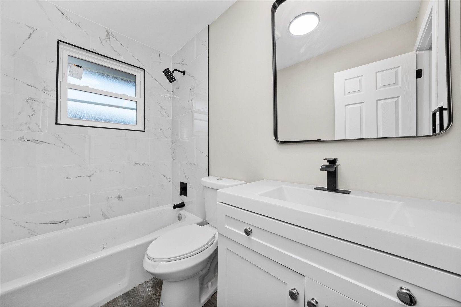 8938 West 85th Place Justice, IL 60458 - Photo 10 of 39 a bathroom with a sink a toilet and a bathtub