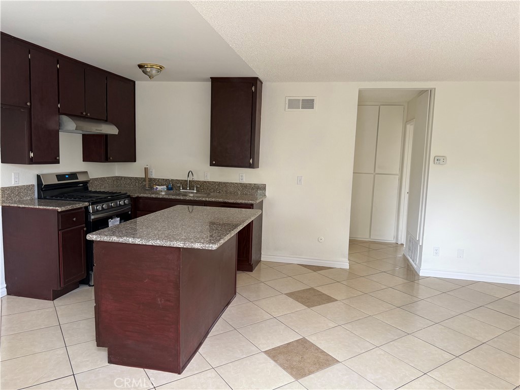 3791-3791 Harvill Lane, Unit 4 Riverside, CA 92503 - Photo 2 of 10 a kitchen with a stove top oven and cabinets