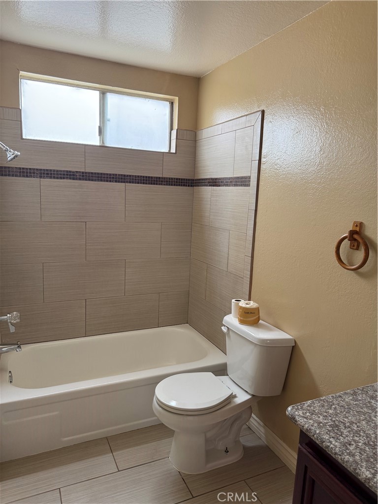 3791-3791 Harvill Lane, Unit 4 Riverside, CA 92503 - Photo 6 of 10 a bathroom with a toilet a sink and a bathtub