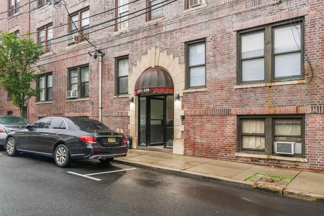 a view of a car parked in front of a brick building