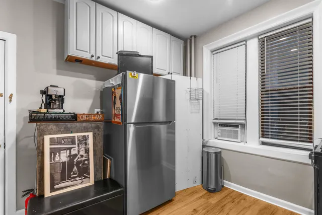 a kitchen with stainless steel appliances a refrigerator and a window