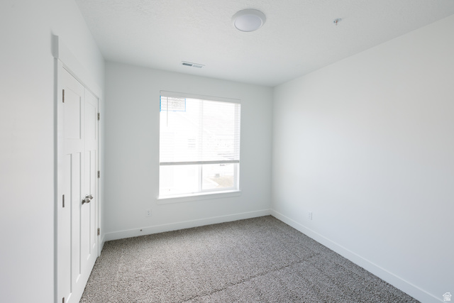 4653 South Alder Drive, Unit H304 Mapleton, UT 84664 - Photo 10 of 14 Unfurnished bedroom with light colored carpet and a closet