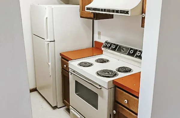 a kitchen with a stove and a refrigerator