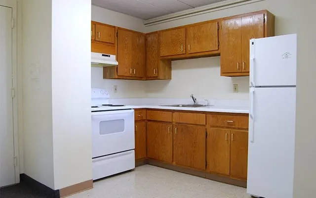 a kitchen with a sink and a refrigerator