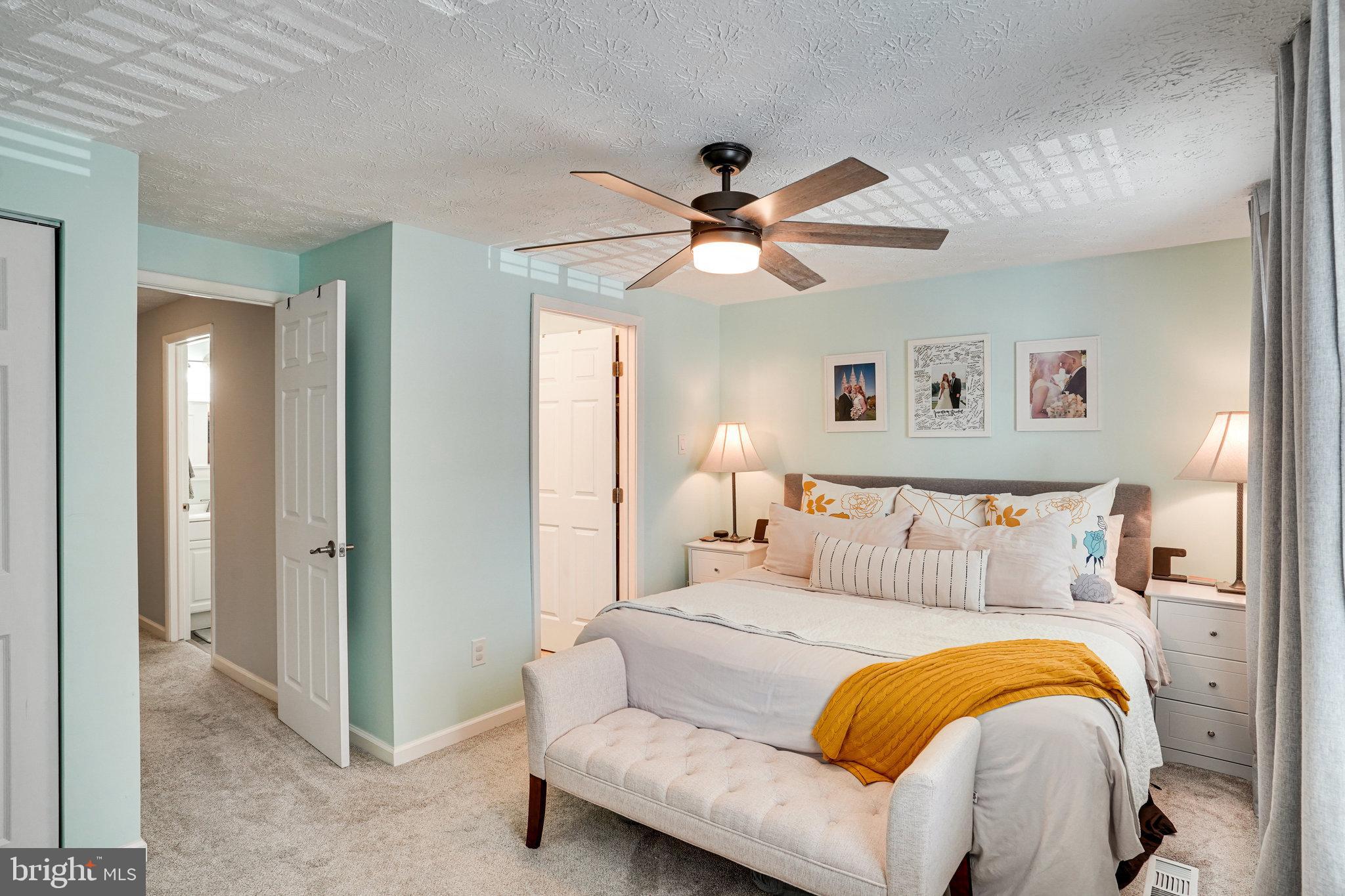 8345 Windfall Road Springfield, VA 22153 - Photo 12 of 30 a bedroom with a bed and a chandelier