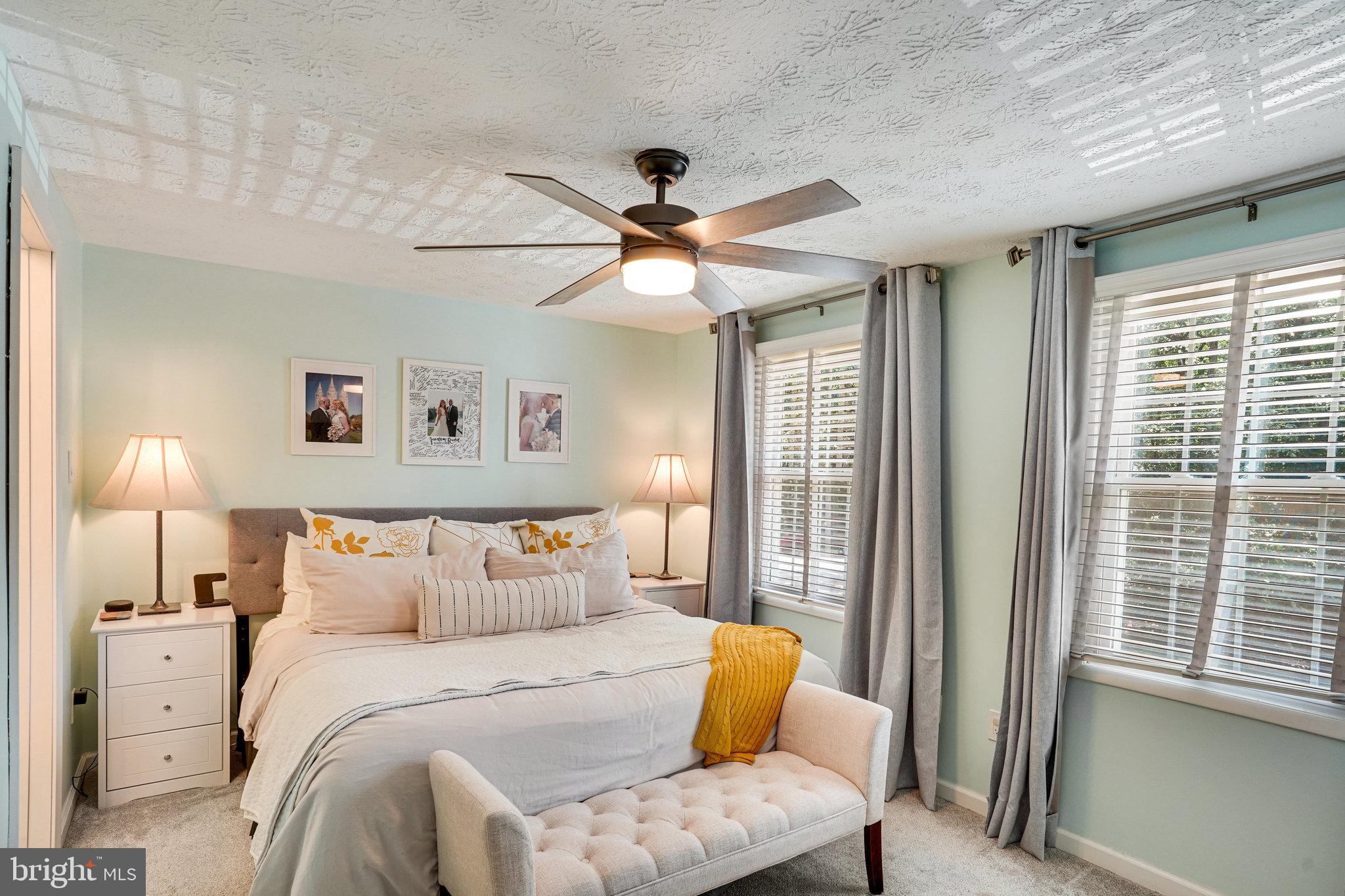 8345 Windfall Road Springfield, VA 22153 - Photo 13 of 30 a bedroom with a bed and a chandelier