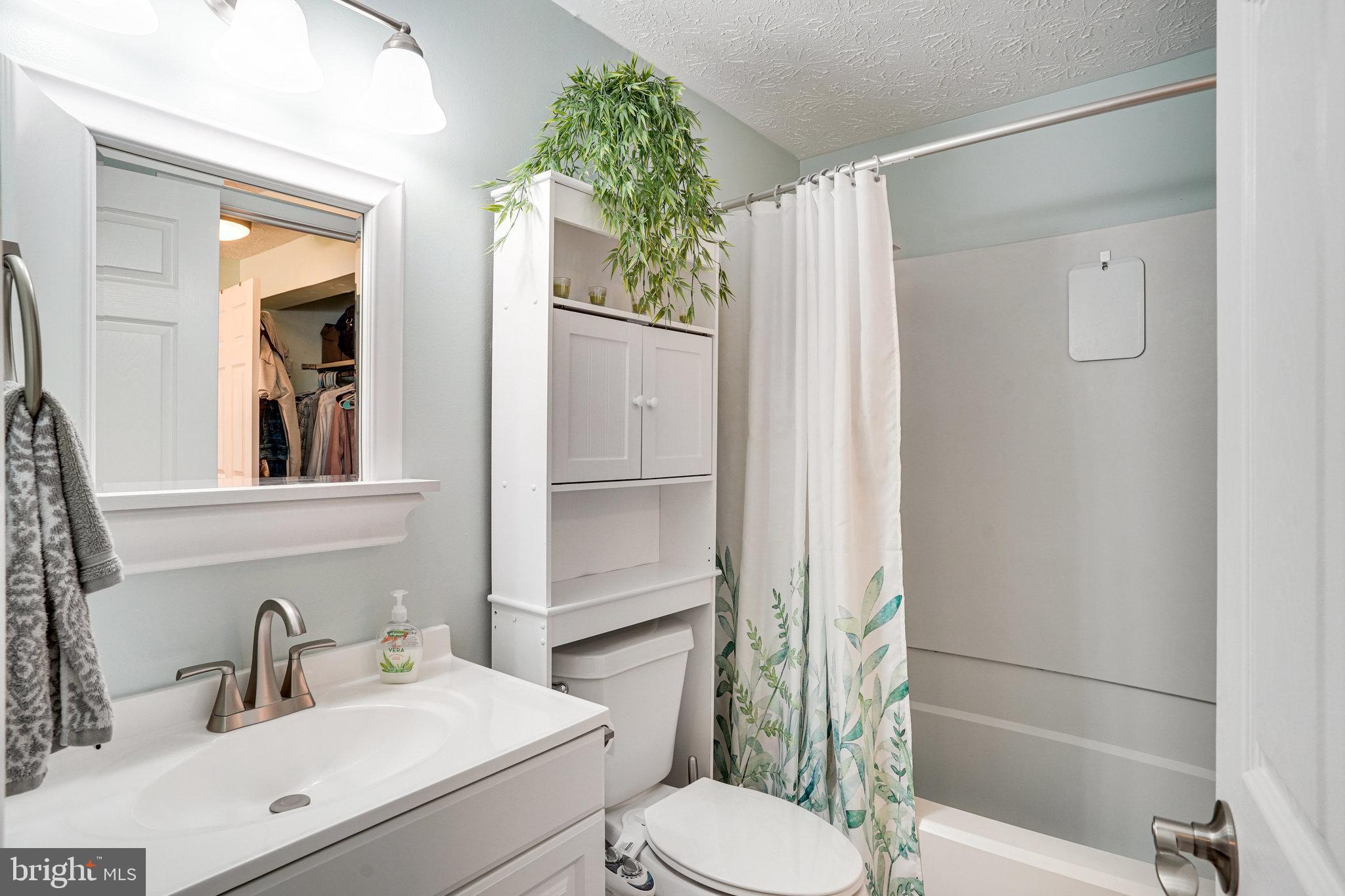 8345 Windfall Road Springfield, VA 22153 - Photo 15 of 30 a bathroom with a sink toilet and shower