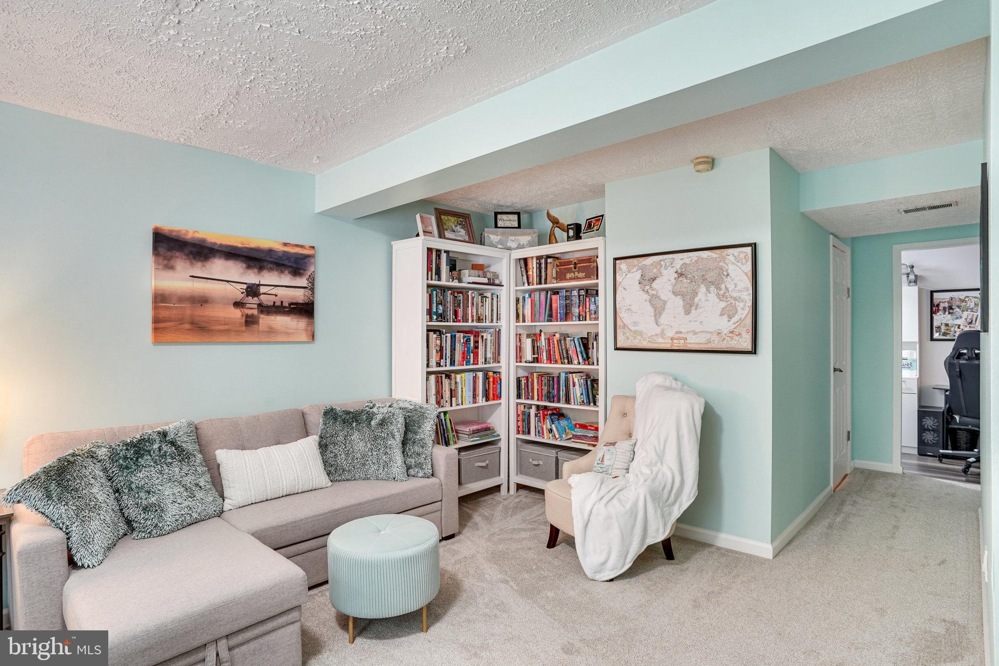 8345 Windfall Road Springfield, VA 22153 - Photo 18 of 30 a living room with furniture and a book shelf