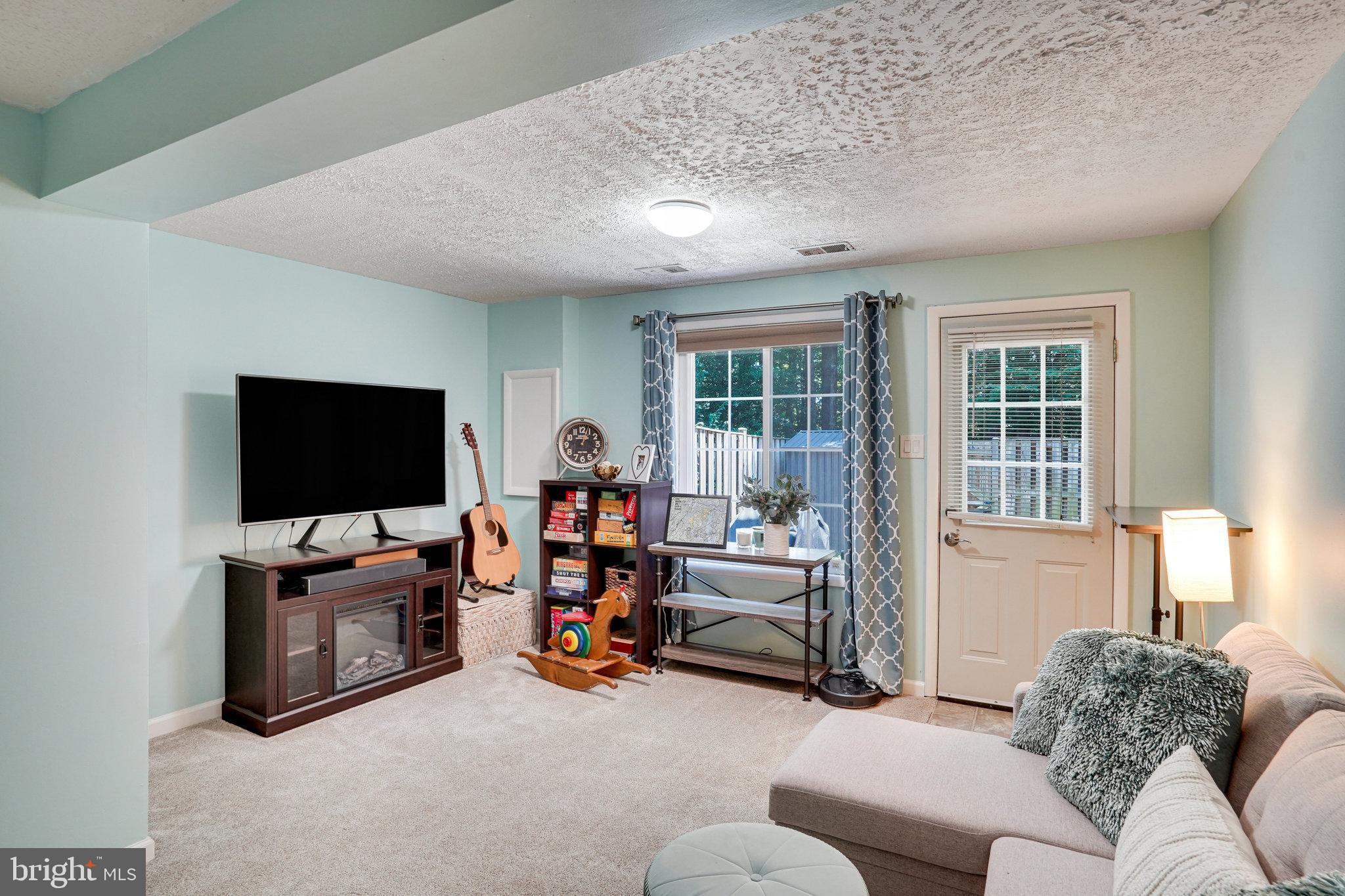 8345 Windfall Road Springfield, VA 22153 - Photo 19 of 30 a living room with furniture and a flat screen tv