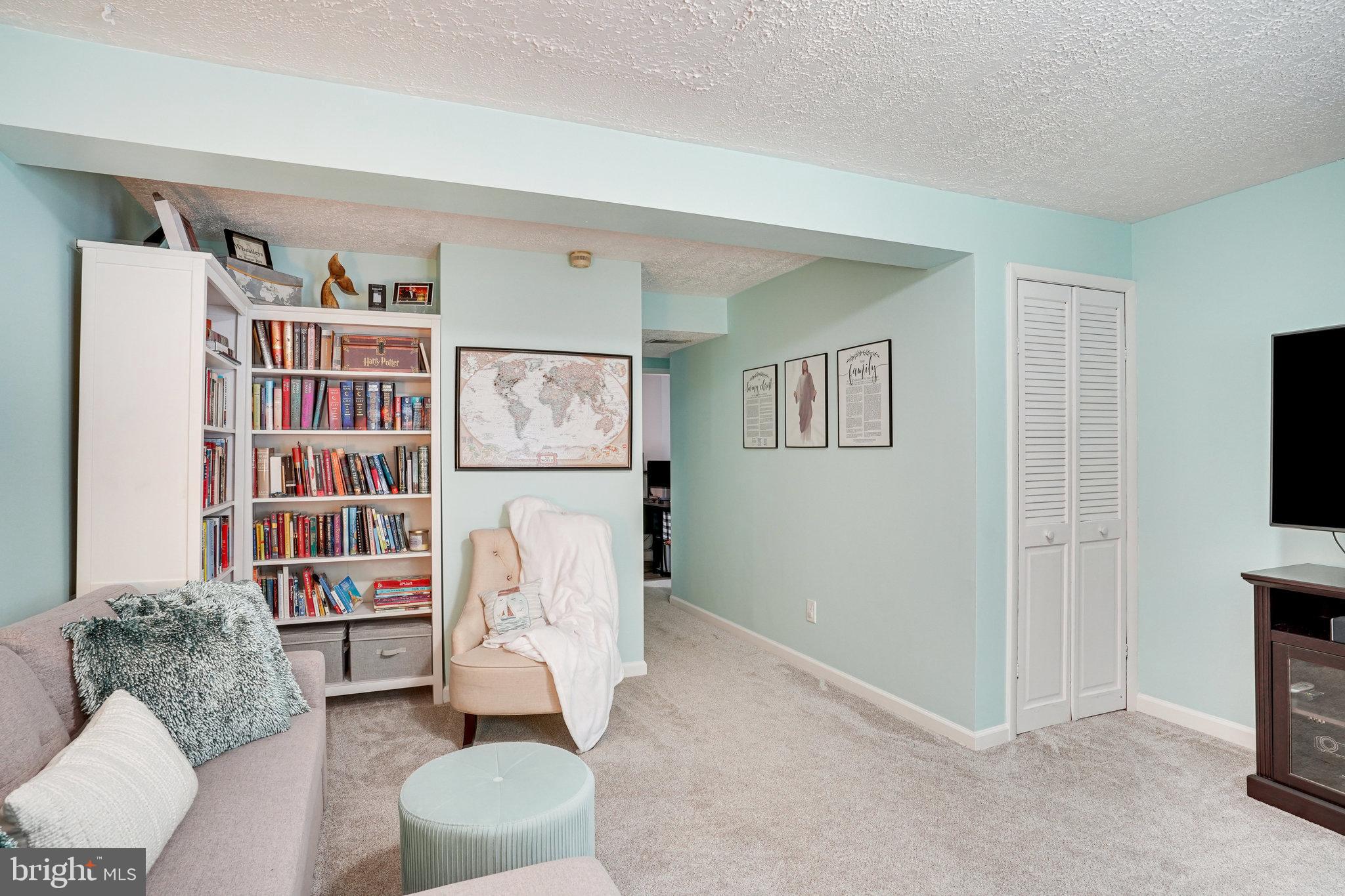8345 Windfall Road Springfield, VA 22153 - Photo 20 of 30 a living room with furniture and a bookshelf