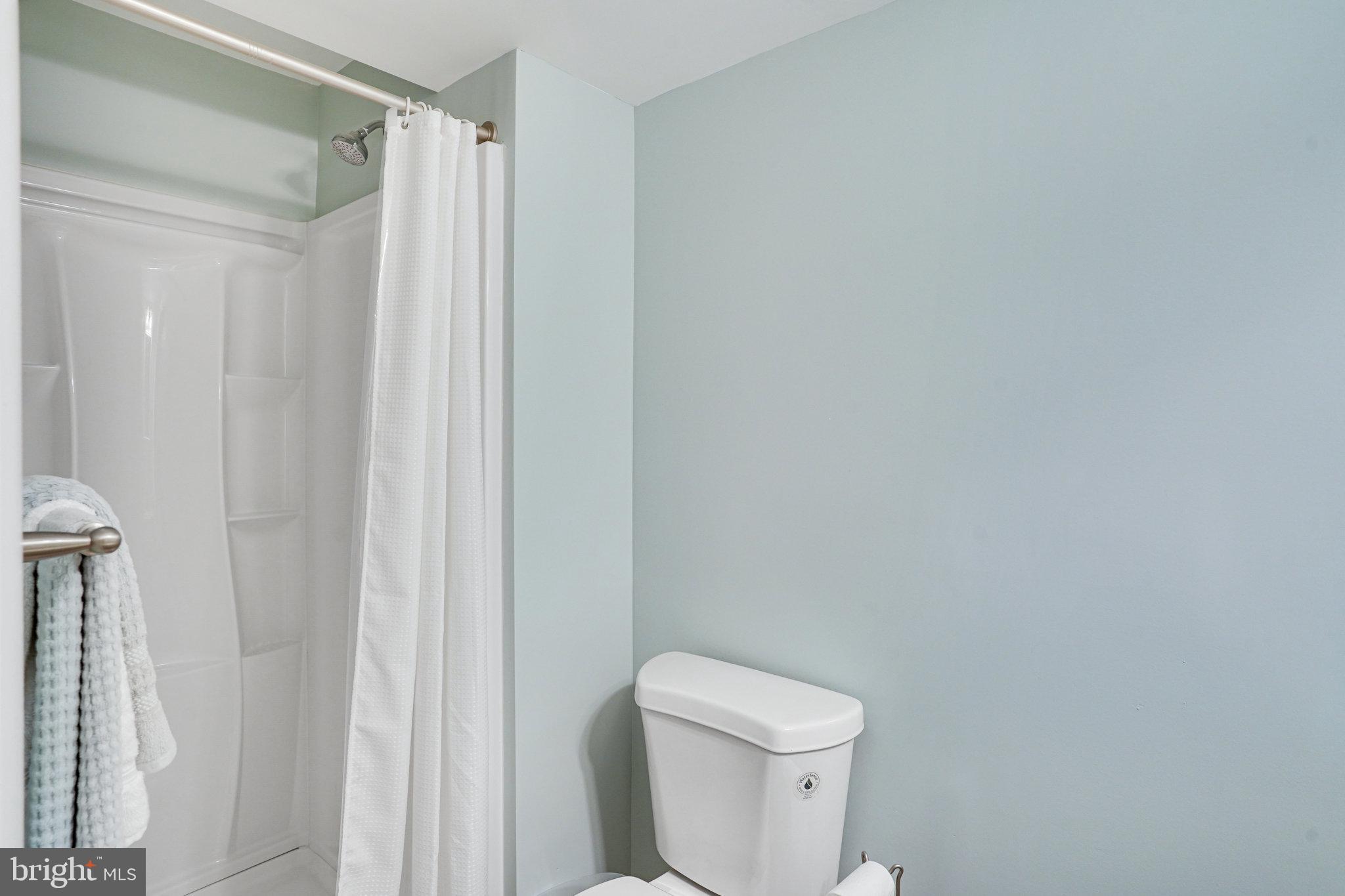 8345 Windfall Road Springfield, VA 22153 - Photo 22 of 30 a white toilet sitting next to a shower