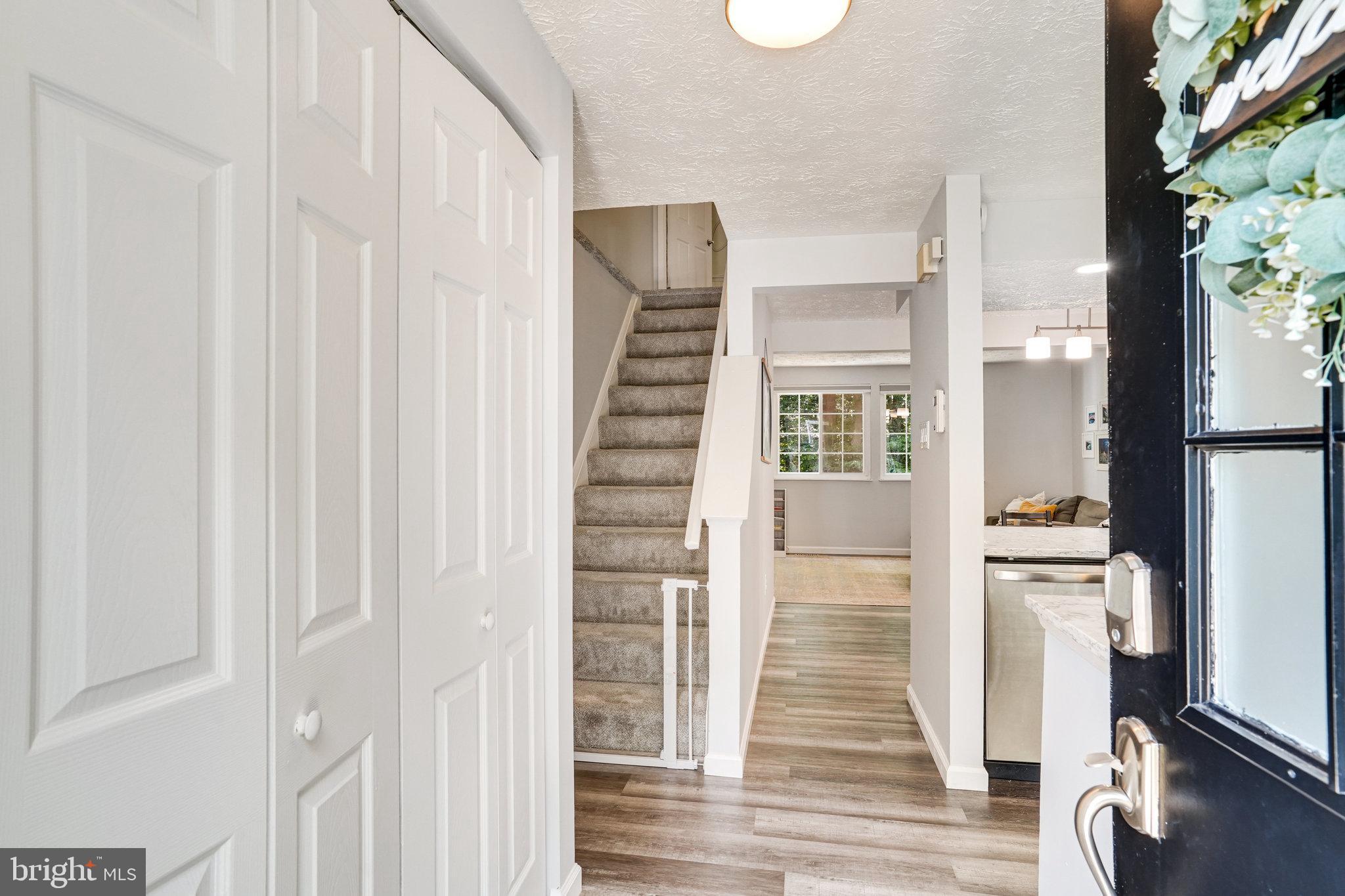 8345 Windfall Road Springfield, VA 22153 - Photo 4 of 30 a view of a hallway with wooden floor and staircase