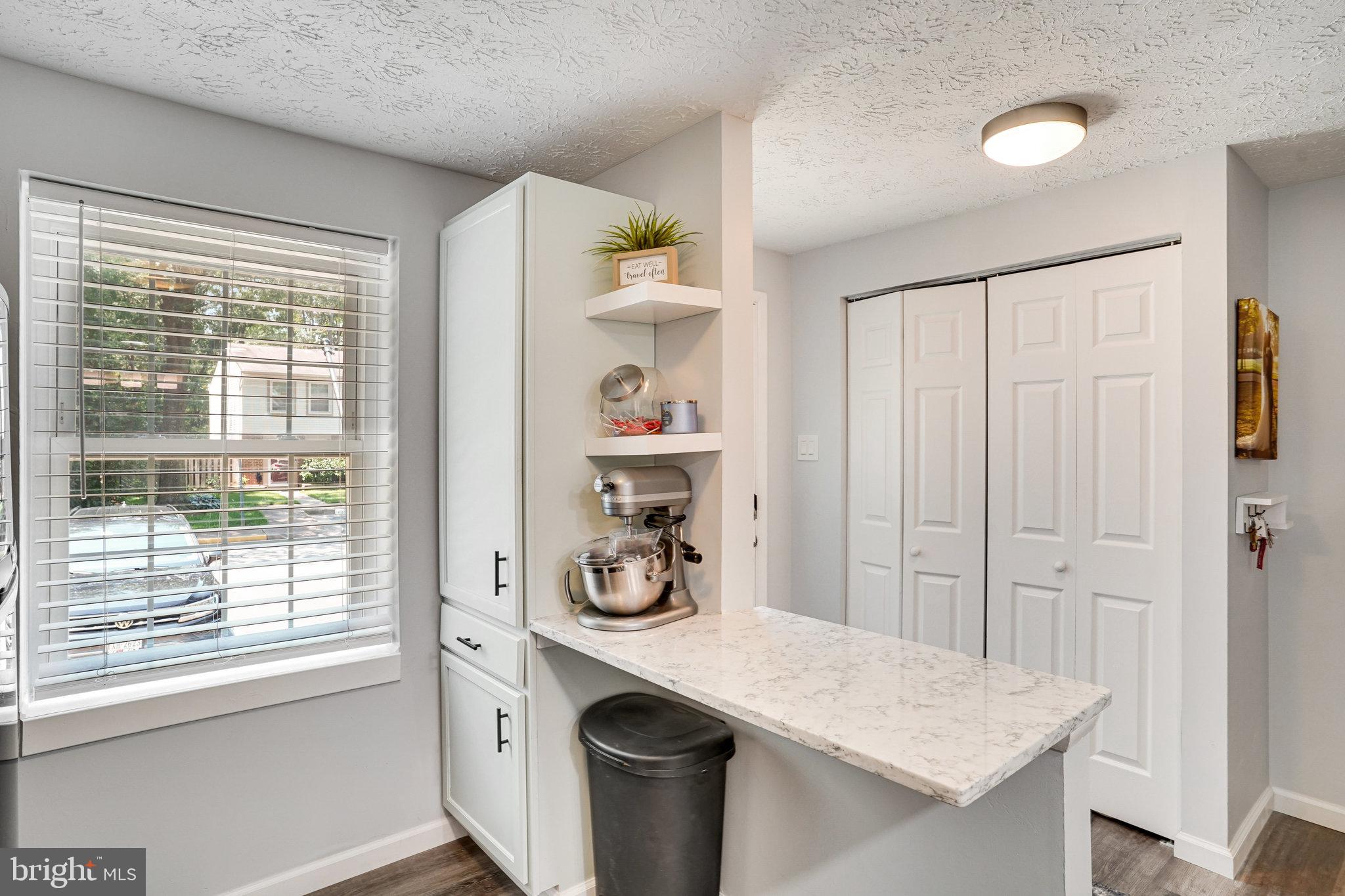8345 Windfall Road Springfield, VA 22153 - Photo 7 of 30 a view of kitchen island with furniture and wooden floor