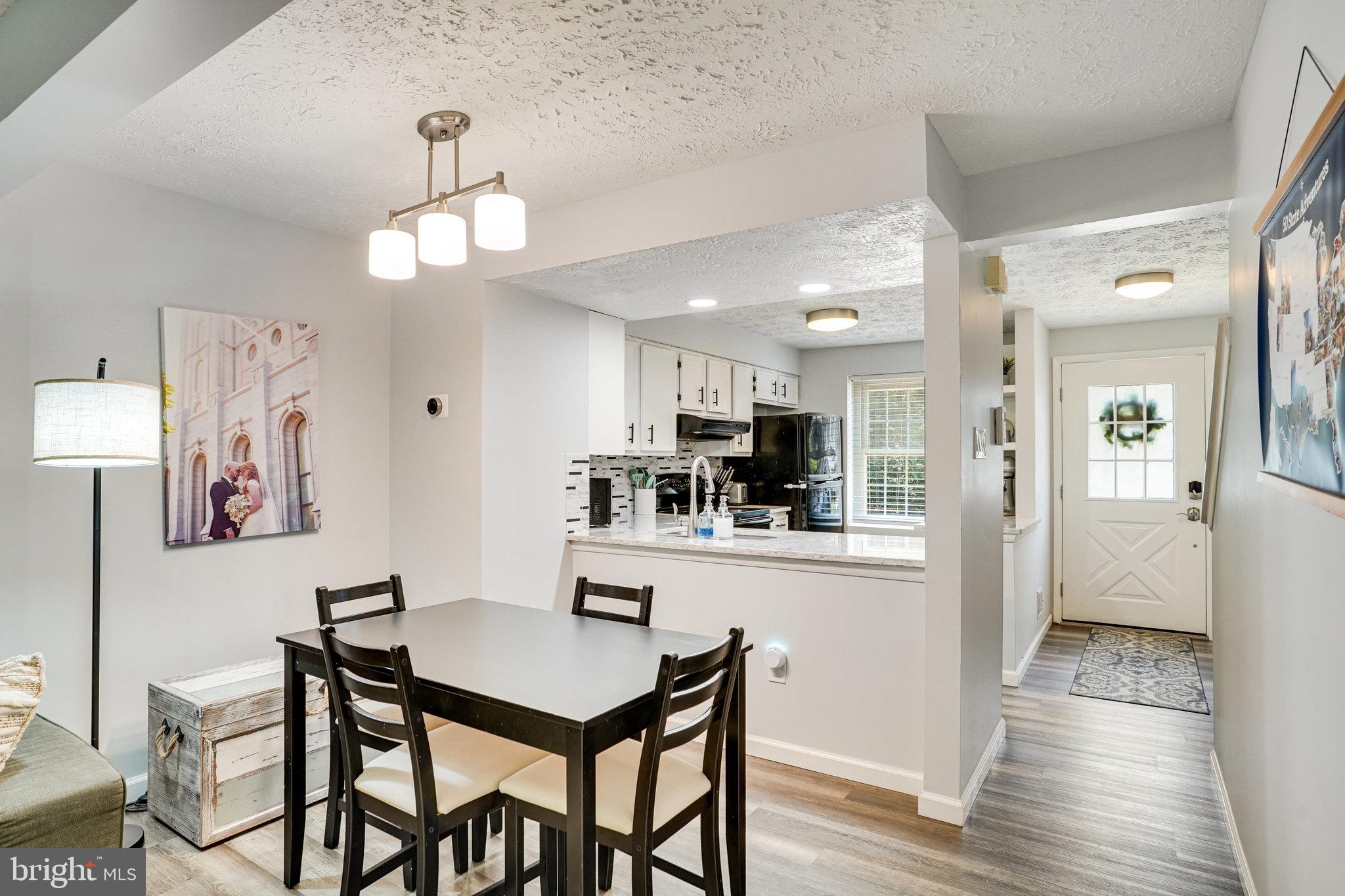 8345 Windfall Road Springfield, VA 22153 - Photo 8 of 30 a view of a dining room with furniture and wooden floor