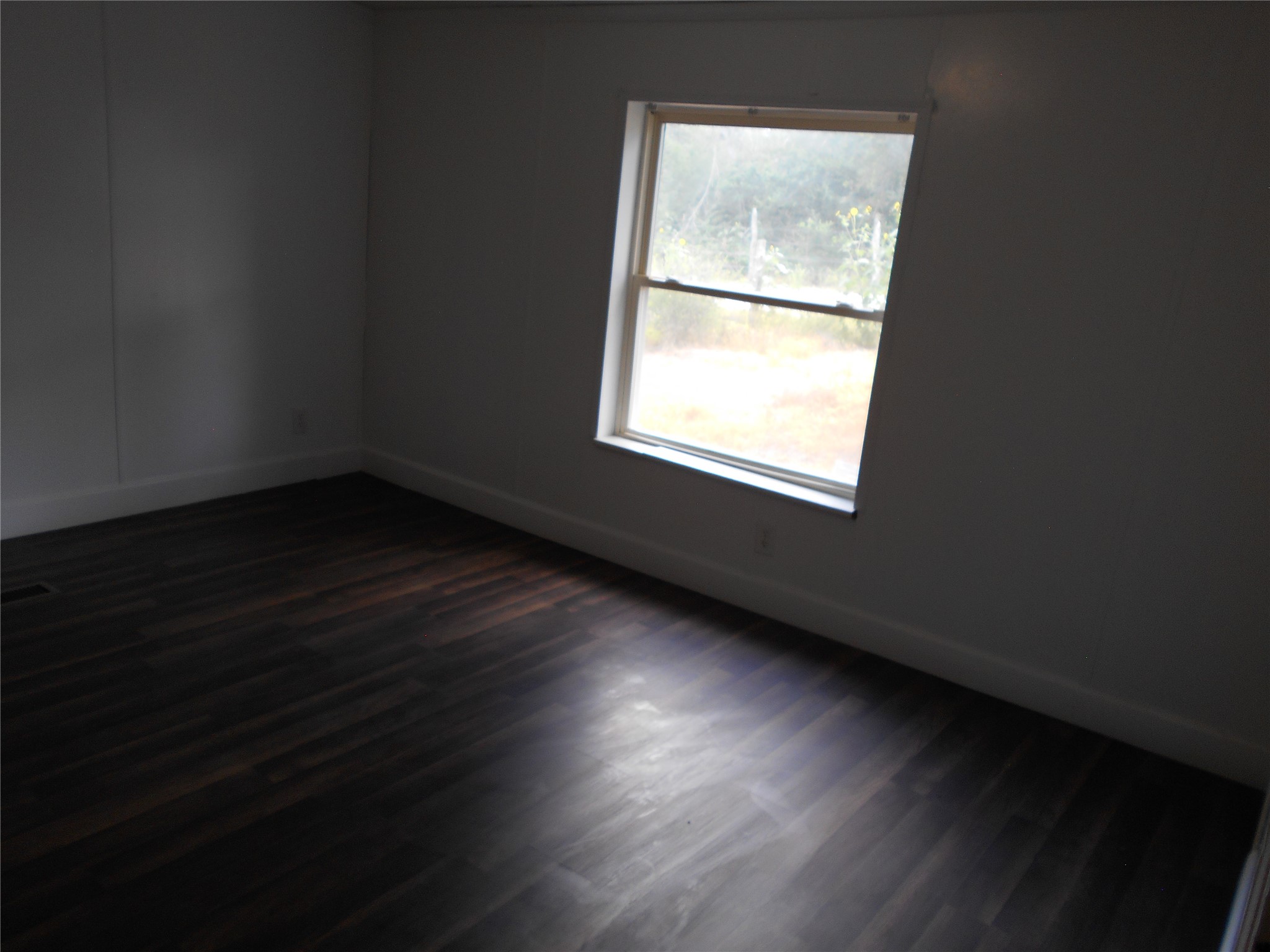 8001 Burleson Manor Road Manor, TX 78653 - Photo 11 of 31 Rich hardwood-style flooring extends across this naturally lit room.