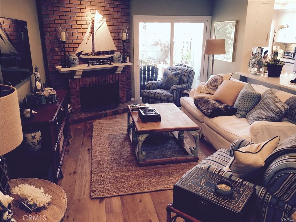 16 Goldstone Irvine, CA 92614 - Photo 5 of 14 Family room w/fireplace and real wood floors