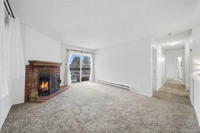 a view of an empty room with fire place and a fireplace