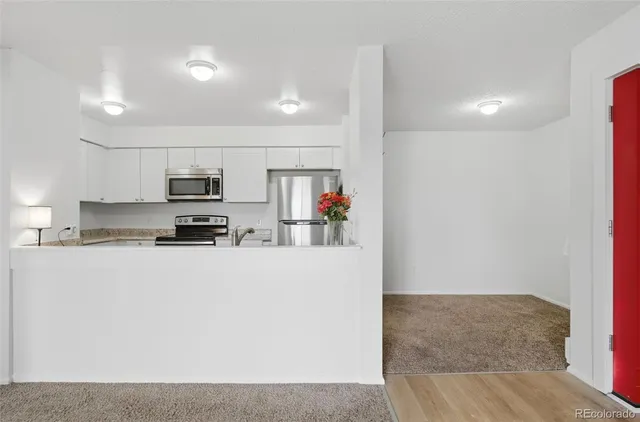 a kitchen with stainless steel appliances a refrigerator and a stove top oven