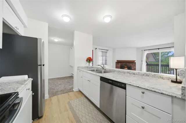 a kitchen with granite countertop a sink and a stove top oven