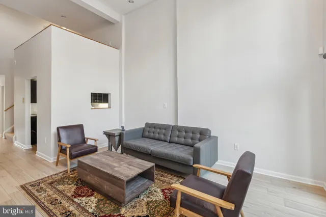 a view of a dining room with furniture and a potted plant