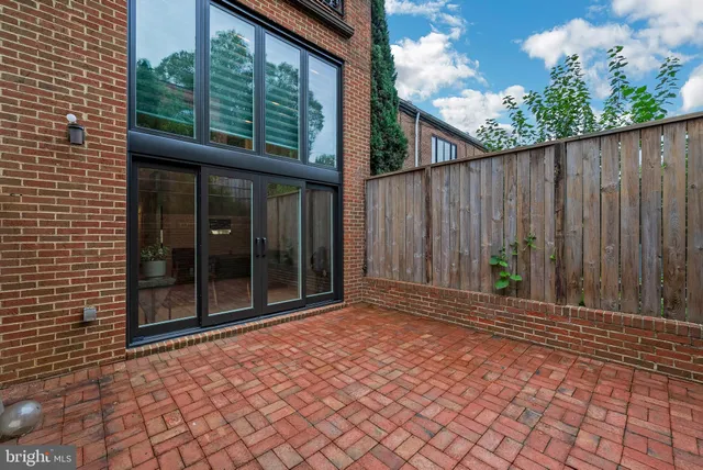 a front view of a building with a garden