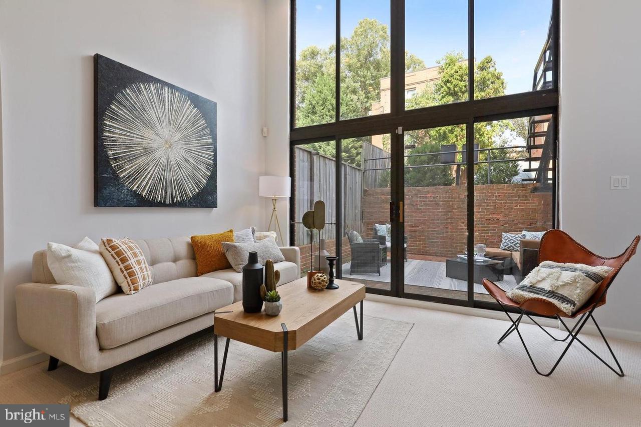 2519 I Street Northwest, Unit 1 Washington, DC 20037 - Photo 5 of 71 a living room with furniture and a large window