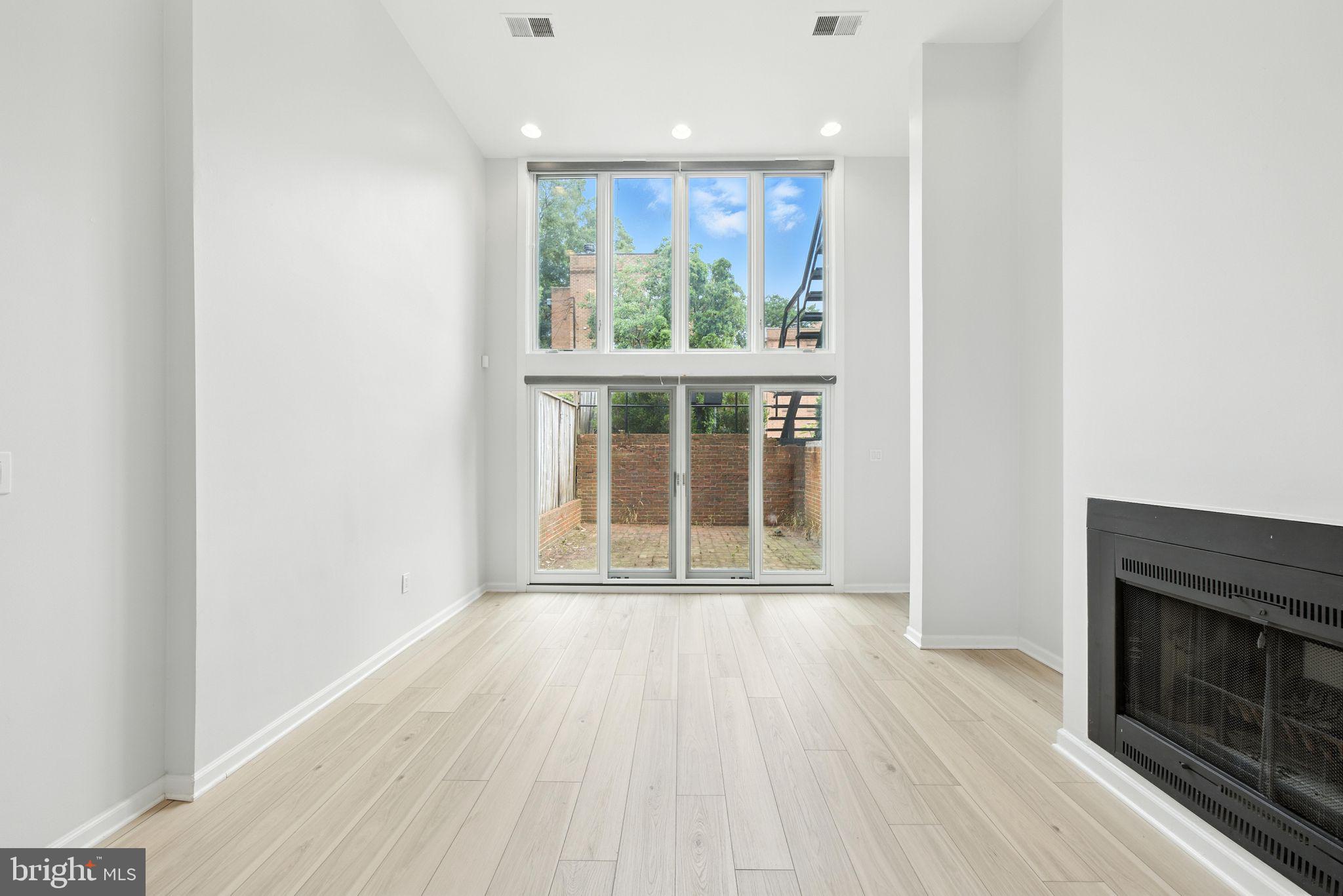 2519 I Street Northwest, Unit 1 Washington, DC 20037 - Photo 55 of 71 a view of an empty room with wooden floor and a window