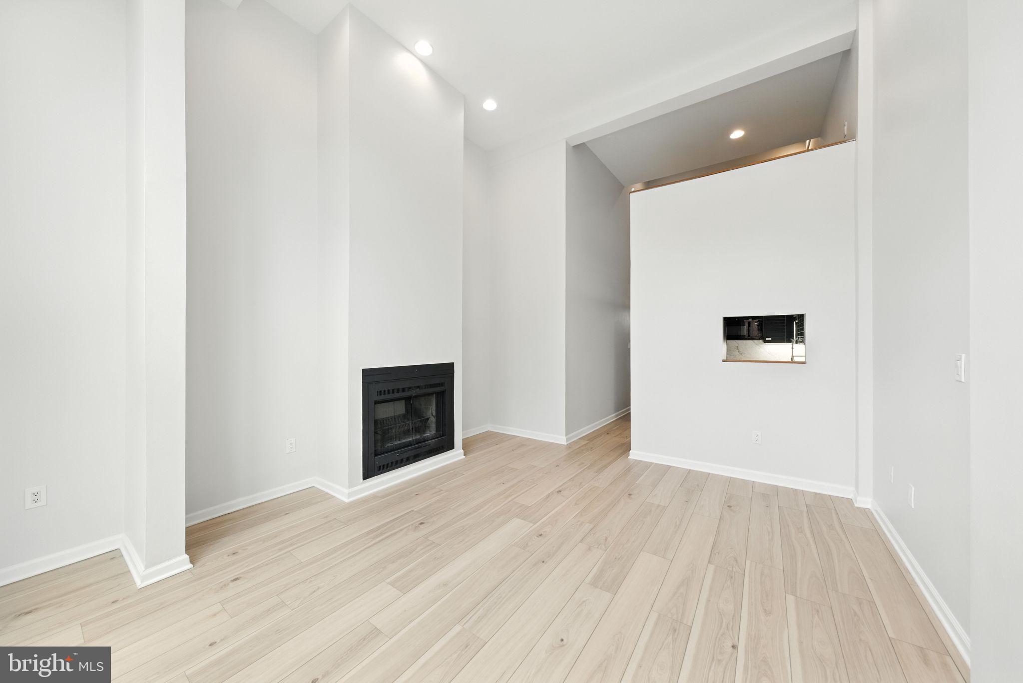 2519 I Street Northwest, Unit 1 Washington, DC 20037 - Photo 57 of 71 an empty room with wooden floor and fireplace