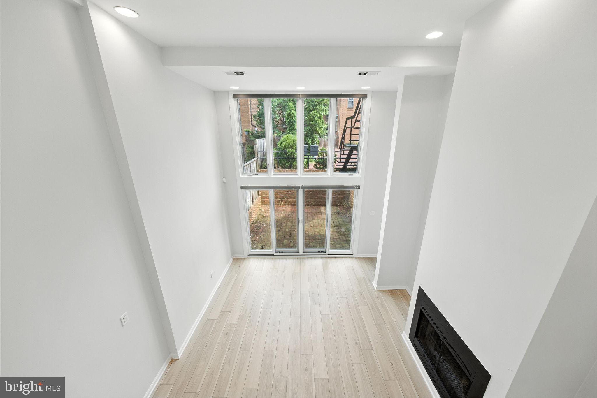 2519 I Street Northwest, Unit 1 Washington, DC 20037 - Photo 63 of 71 an empty room with wooden floor and windows