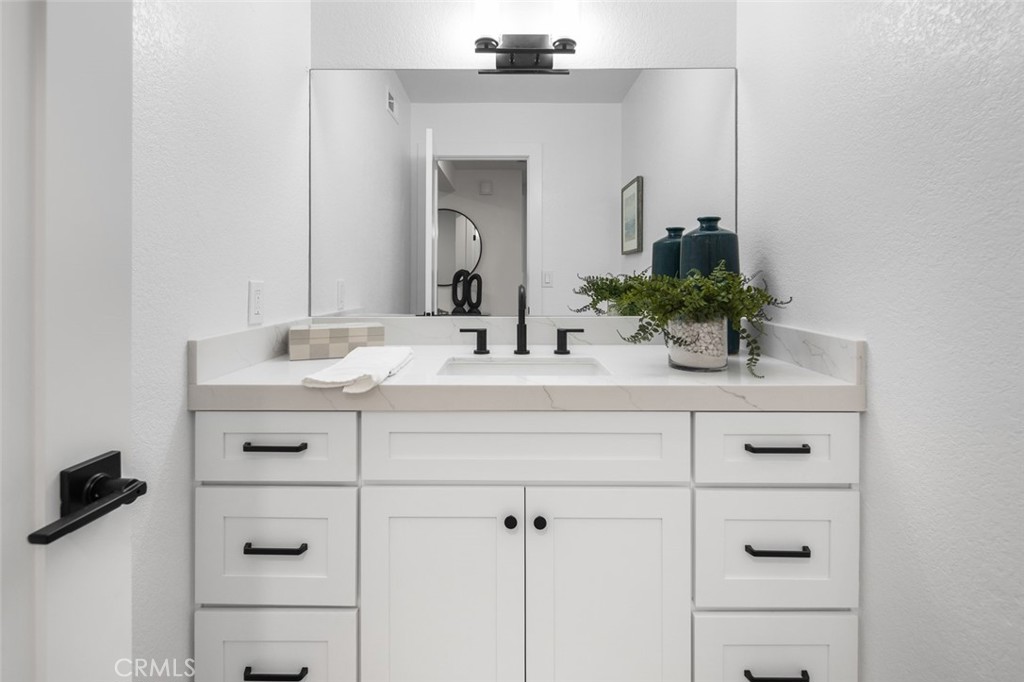 3905 Hazard Avenue, Unit B22 Santa Ana, CA 92703 - Photo 14 of 30 a bathroom with a sink vanity and a mirror