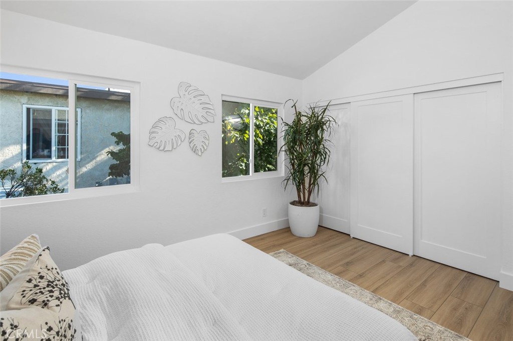 3905 Hazard Avenue, Unit B22 Santa Ana, CA 92703 - Photo 22 of 30 a bedroom with a bed and a potted plant