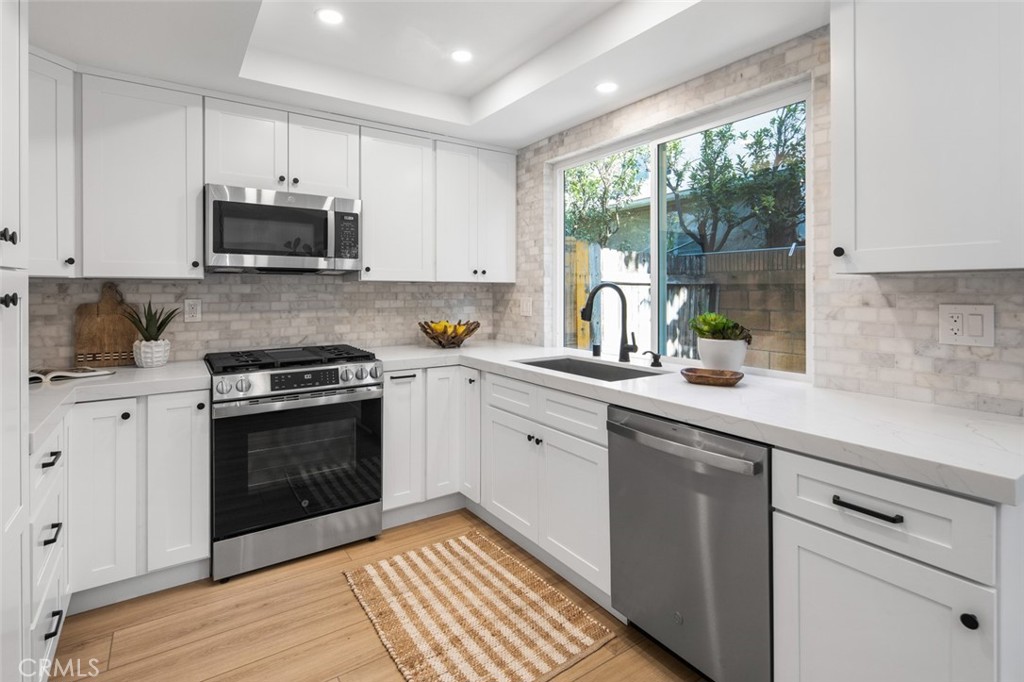 3905 Hazard Avenue, Unit B22 Santa Ana, CA 92703 - Photo 8 of 30 a kitchen with a sink stove and microwave
