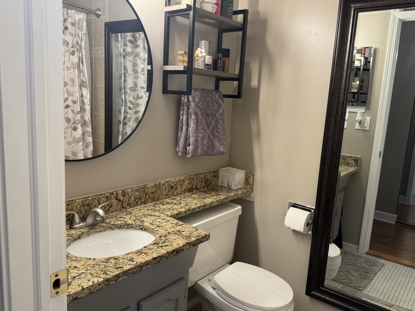 1926 Prairie Square, Unit 302 Schaumburg, IL 60173 - Photo 10 of 16 a bathroom with a granite countertop toilet sink and mirror