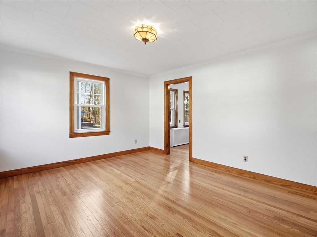 285 West Meadow Road Lowell, MA 01854 - Photo 14 of 32 a view of an empty room with a window and wooden floor