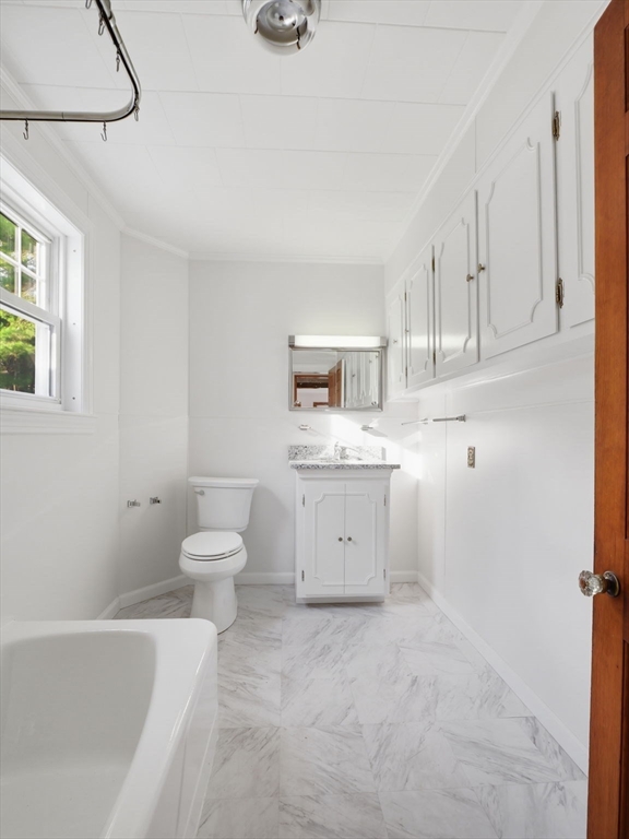 285 West Meadow Road Lowell, MA 01854 - Photo 16 of 32 a view of a kitchen with white cabinets and white appliances