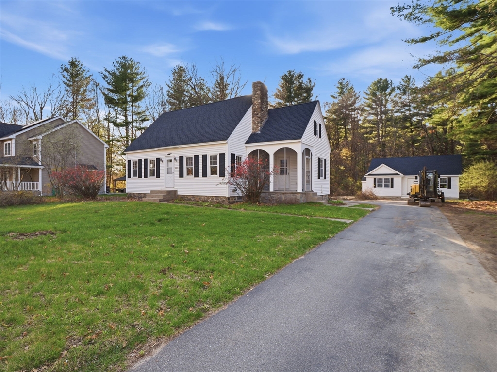 285 West Meadow Road Lowell, MA 01854 - Photo 2 of 32 a view of a white house with a big yard and large trees
