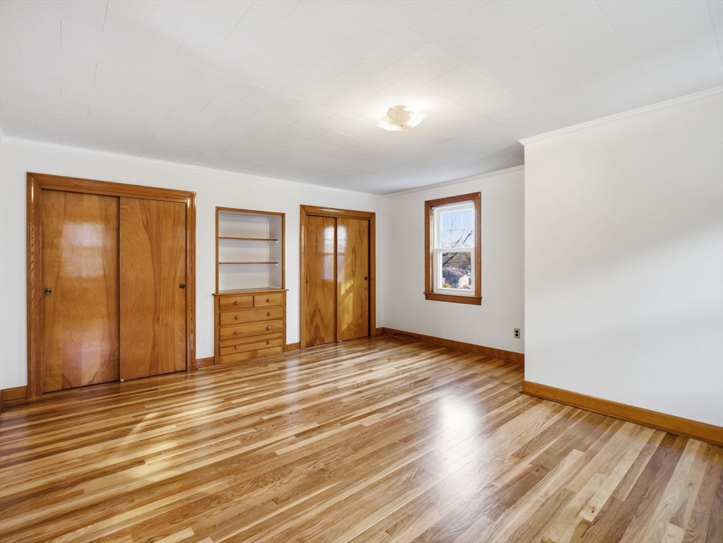 285 West Meadow Road Lowell, MA 01854 - Photo 23 of 32 a view of an empty room with window and wooden floor