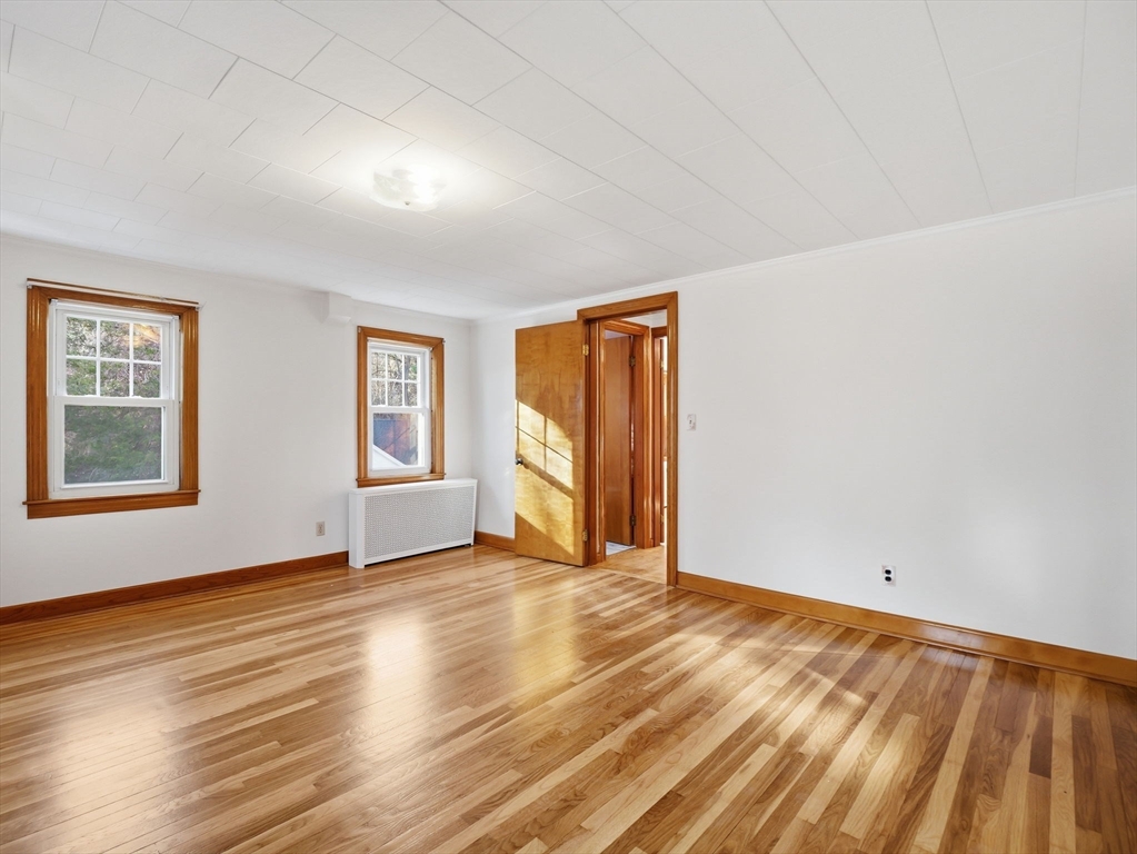 285 West Meadow Road Lowell, MA 01854 - Photo 24 of 32 a view of an empty room with window and wooden floor