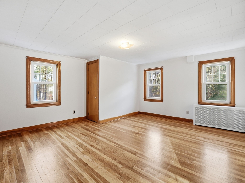285 West Meadow Road Lowell, MA 01854 - Photo 25 of 32 a view of an empty room with window and wooden floor