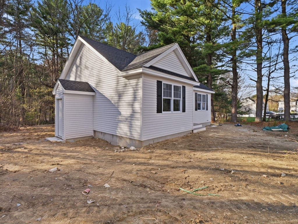 285 West Meadow Road Lowell, MA 01854 - Photo 31 of 32 a front view of a house with a yard